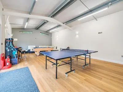 a ping pong room with a ping pong table in it at Old Rectory Cottages in Aberhafesp