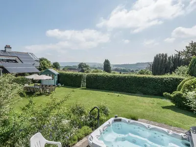 a garden with a hot tub in the yard at The Old Schoolhouse and Cottage in Bishops Castle