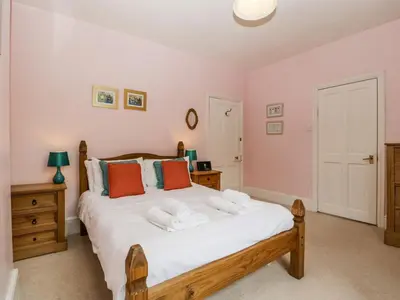 a bedroom with a bed with towels on it at Wheelbarrow Castle in Stoke Prior