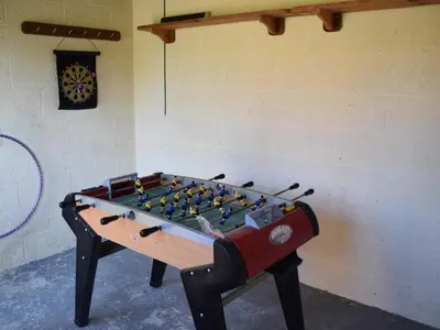 a ping pong table in a room with at Parrs Meadow Cottage in Pitchford