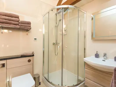 a bathroom with a shower and a sink at Parrs Meadow Cottage in Pitchford