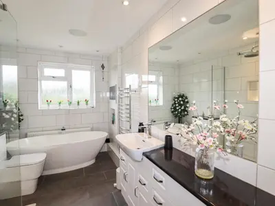 a white bathroom with a tub and a sink and a bath tub at Tregarthens in Church Stretton