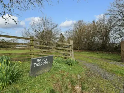 a wooden fence with a sign that says baby doggieologist at Beudy Dolpebyll in Llangadfan