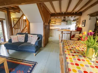 a living room with a couch and a table at Beudy Dolpebyll in Llangadfan