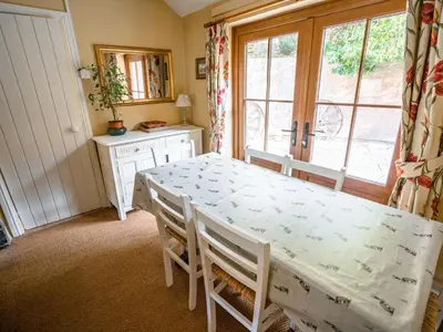a dining room with a table and chairs and a window at The Wilderness in Bromlow