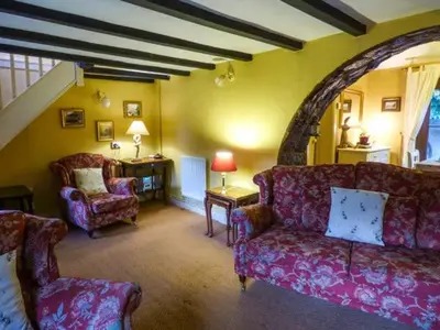 a living room with a couch and a chair at The Wilderness in Bromlow