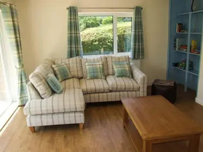 a living room with a couch and a table at Cwmgilla Farm in Knighton
