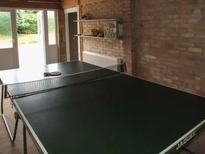 a ping pong table in the middle of a room at Cwmgilla Farm in Knighton