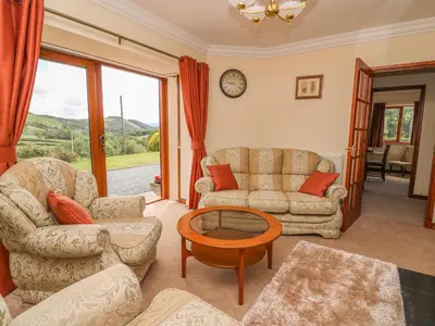 a living room with two couches and a table at Drainbyrion Farm House in Van