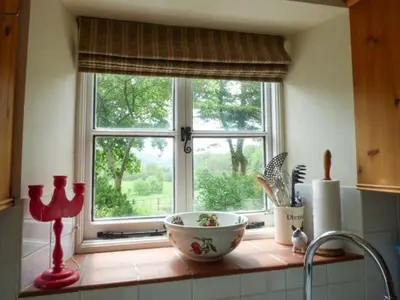 a kitchen counter with a window and a bowl at Crud-y-Barcud in Pumpsaint
