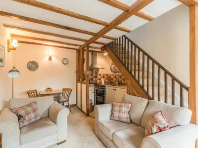 a living room with two couches and a table at Old Town Cottage in Ludlow