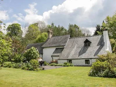 a white house with a gray roof at Penymaes in Chirk