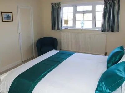 a bedroom with a large white bed and a window at Harris House in Ludlow