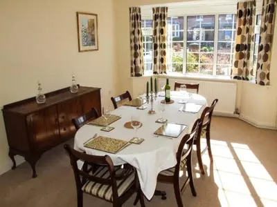 a dining room with a white table and chairs at Harris House in Ludlow