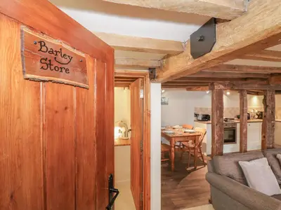 a living room with a couch and a table at The Barley Store in Craven Arms
