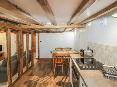 a kitchen with a table and a counter top at The Barley Store in Craven Arms
