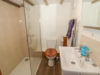 a bathroom with a toilet and a sink and a shower at The Barley Store in Craven Arms