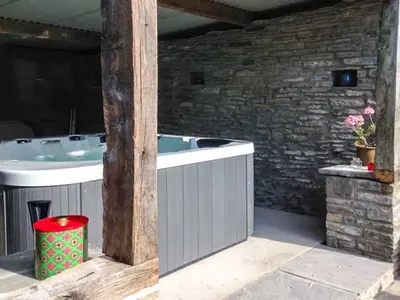 a bath tub and a sink in a room at Gatehouse in Painscastle