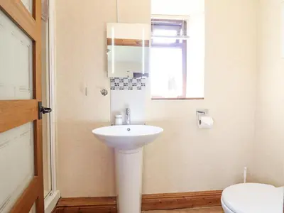 a bathroom with a white sink and a toilet at Bwthyn Ty Newydd in Pont Dolanog