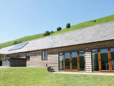 a log cabin with a grass roof at 2 Beacon View Barn in Felindre