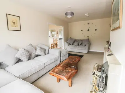 a living room with a couch and a coffee table at Middle Hivron in Bleddfa
