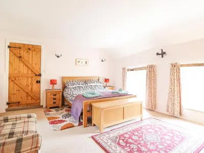 a bedroom with a bed and a wooden desk at Bodywen in Llangynog