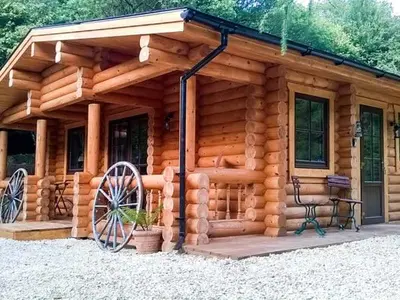 a log cabin with a bench in front of it at Wilderness Lodge in Shelve