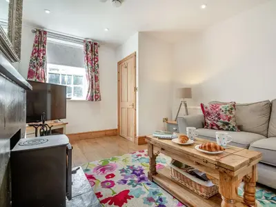 a living room with a couch and a table at Bro Dawel in Dolgellau