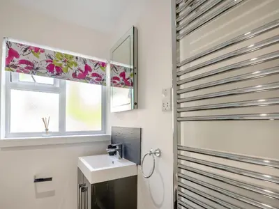 a bathroom with a sink and a window at Bro Dawel in Dolgellau