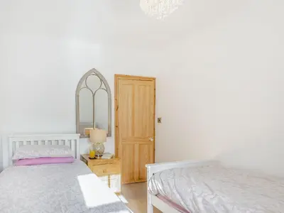 a bedroom with two beds and a mirror at Bro Dawel in Dolgellau