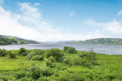 a view of a river with mountains in the background at Waedog Bach in Llanfor