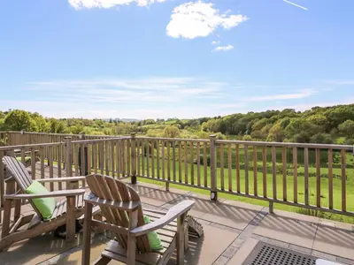 a balcony with chairs and a view of the countryside at Foxes Meadow in Llandrindod Wells