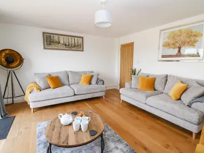 a living room with a couch and a table at Pheasant Wood in Llandrindod Wells