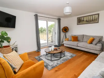 a living room with a couch and a table at Pheasant Wood in Llandrindod Wells
