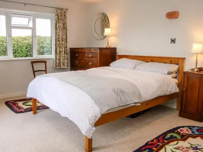 a bedroom with a large bed and a window at Bryn Caer in Chirbury