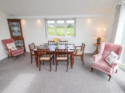 a dining room with a table and chairs at Bryn Caer in Chirbury