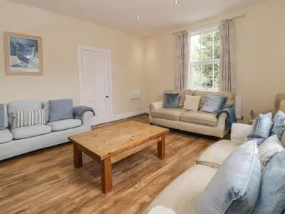 a living room with couches and a coffee table at The Mill House in Carrog