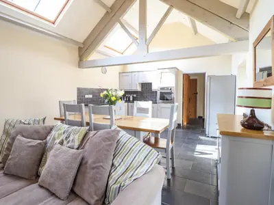 a living room with a couch and a table at Beudy Bach Barn in Llanuwchllyn