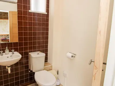 a bathroom with a toilet and a sink at Bicton Lea in Acton