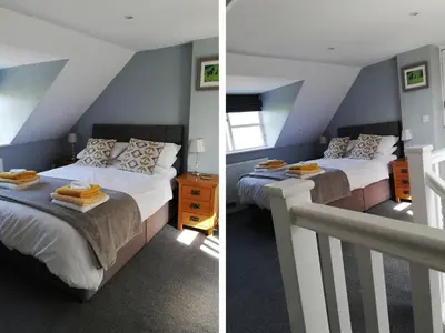 two beds in a room with blue walls at Gwdihw in Ifton Heath
