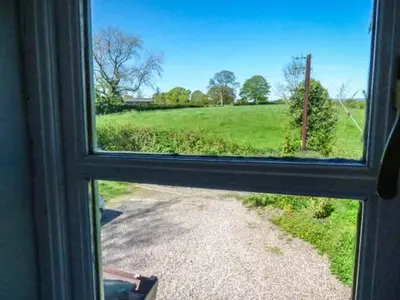 a window view of a field through a window at Gwdihw in Ifton Heath