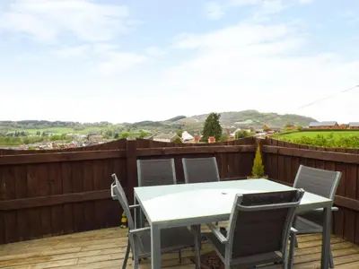 a white table and chairs on a deck with a view at Penylodge in Builth Wells