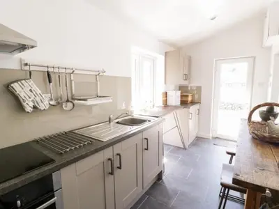 a kitchen with a sink and a counter top at 2 Borthwen Cottages in Dyffryn