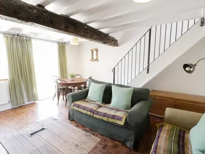 a living room with a couch and a table at 2 Borthwen Cottages in Dyffryn