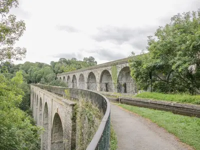 an old stone bridge with a dirt road at Little Beeches in Selattyn