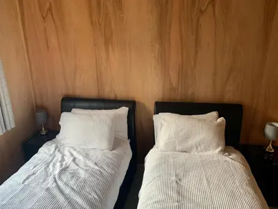 two beds sitting next to each other in a room at Rolling Hills in Newcastle