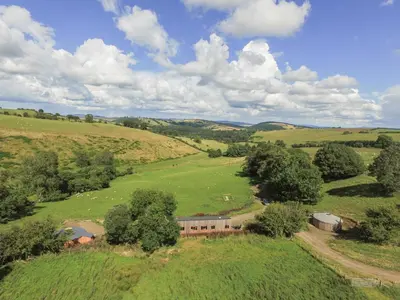 an aerial view of a farm house in a field at Rolling Hills in Newcastle
