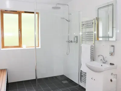 a white bathroom with a sink and a shower at Rolling Hills in Newcastle