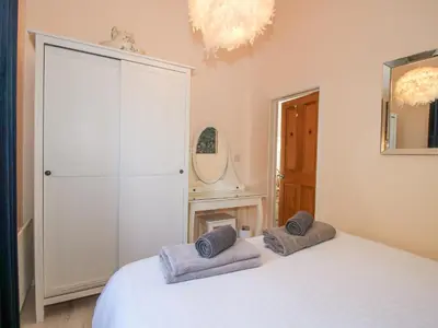 a bedroom with a white bed with towels on it at Stoney-Brook Lodge in Farden