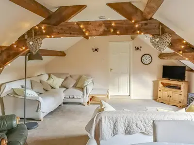 a living room with two beds and a couch at Hen Ysgubor Cottage in Bala